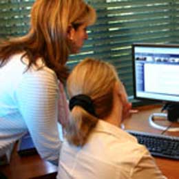 image of coworkers looking at laptop
